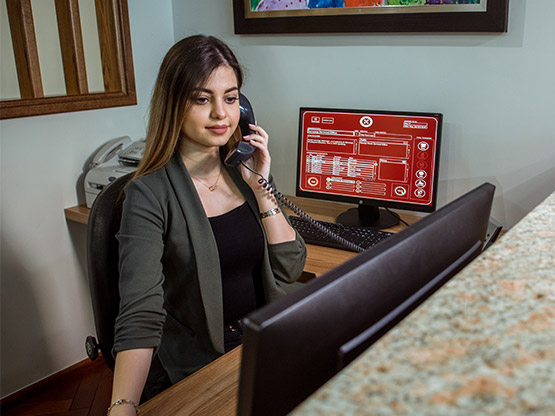 Servcorp receptionist handling calls and mail management.